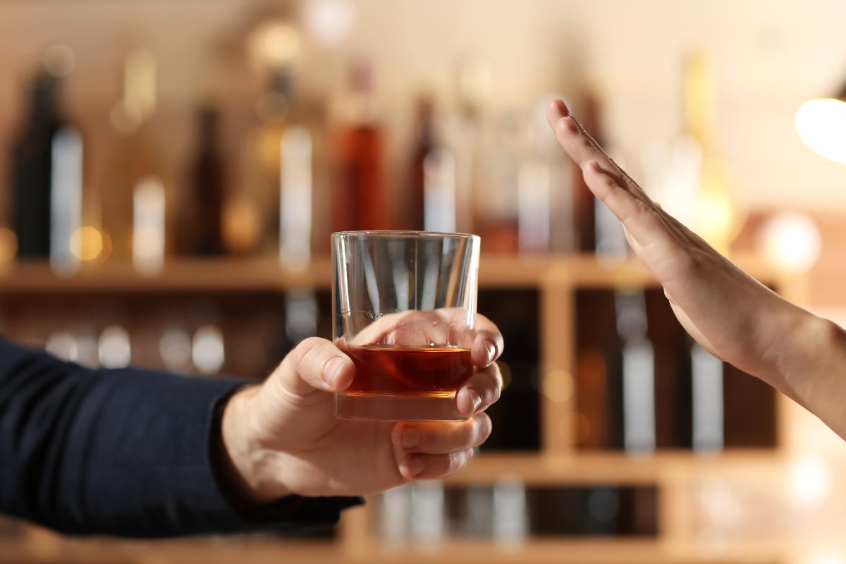 a person says no to a drink in hopes of easing alcohol withdrawal symptoms