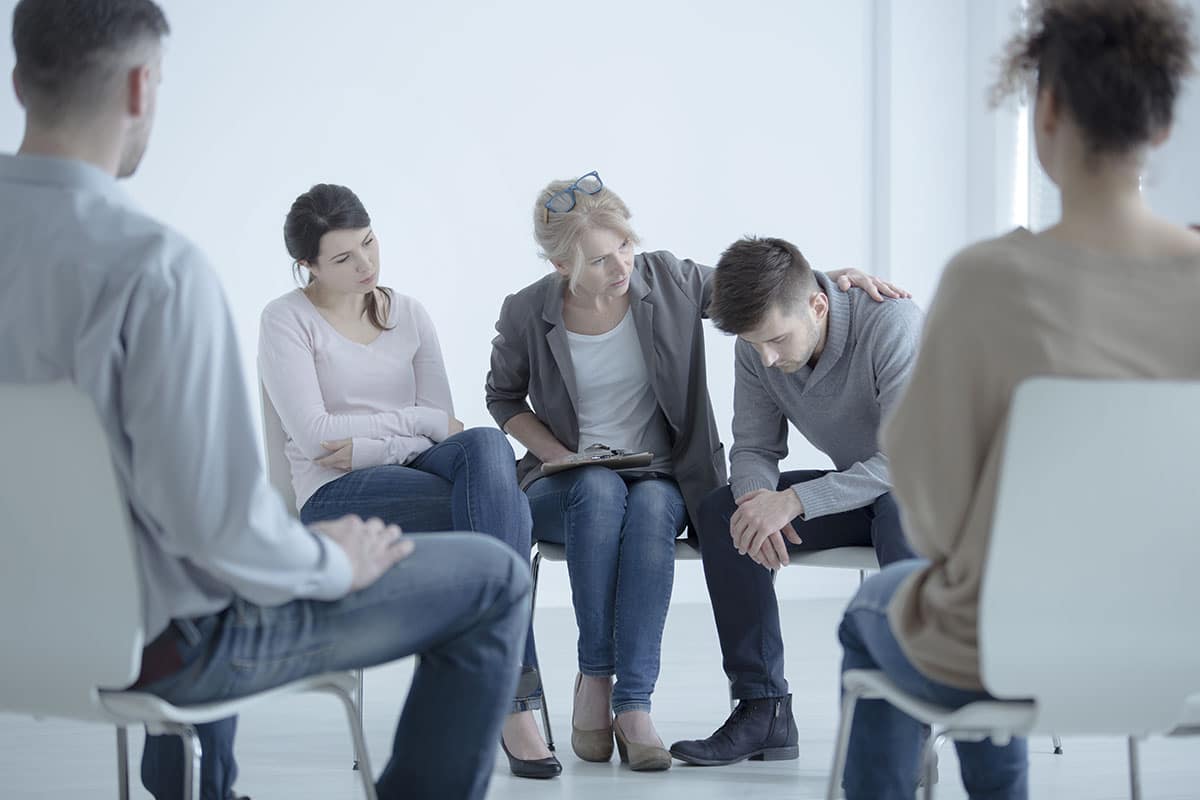 Group gathered around talking about National Depression Screening Day
