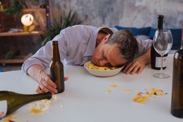 A man suffers from alcoholic dementia and falls asleep at the table
