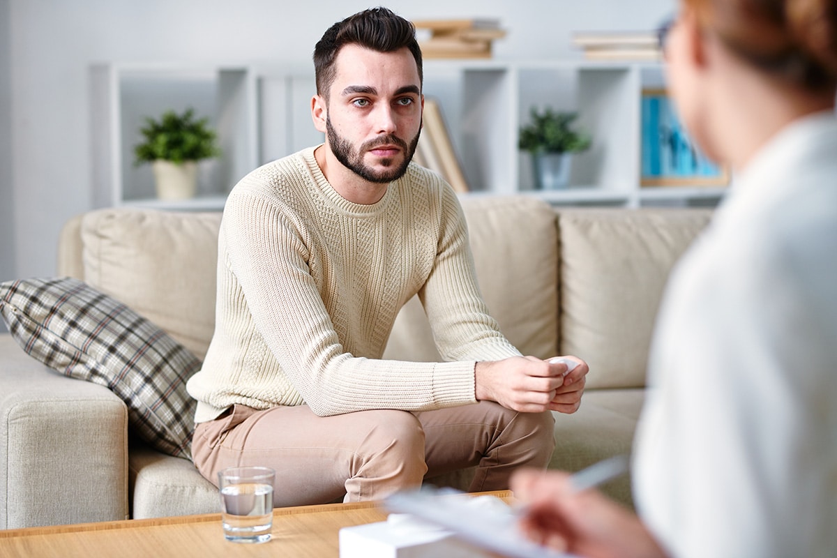 A man talks to his therapist about individual addiction care