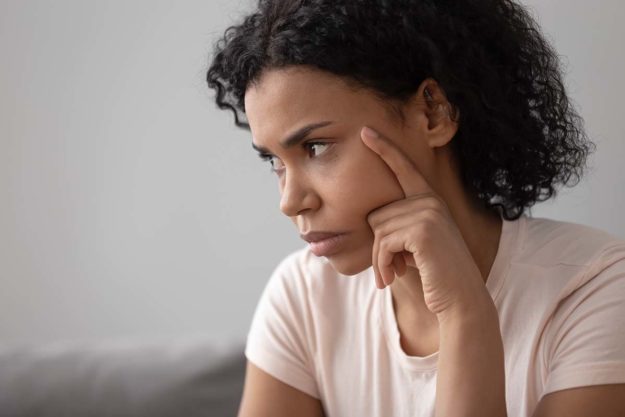 pensive woman wondering about symptoms of vicodin abuse