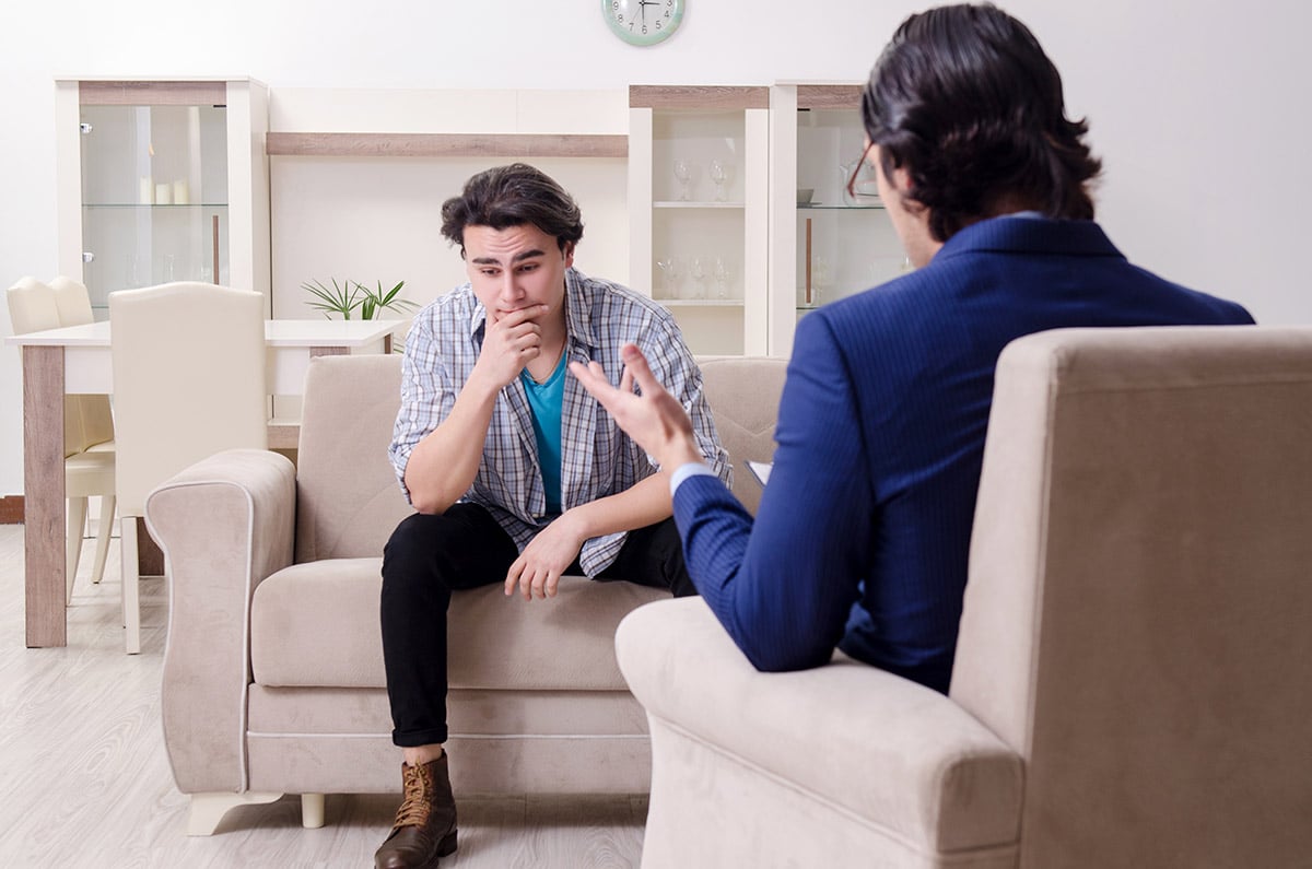 a doctor explaining to a patient how motivational interviewing and addiction treatment can help him get clean
