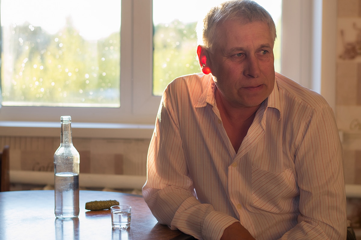 older man ponders alcoholism effects on varying ages