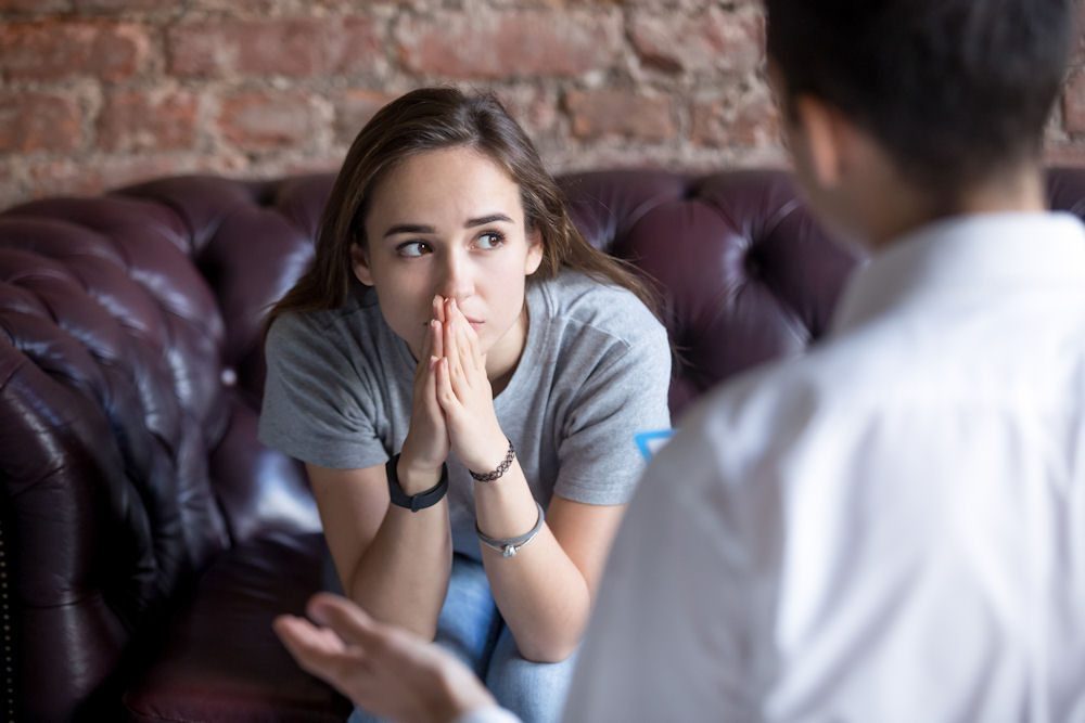 Woman experiencing biological effects of alcoholism during recovery