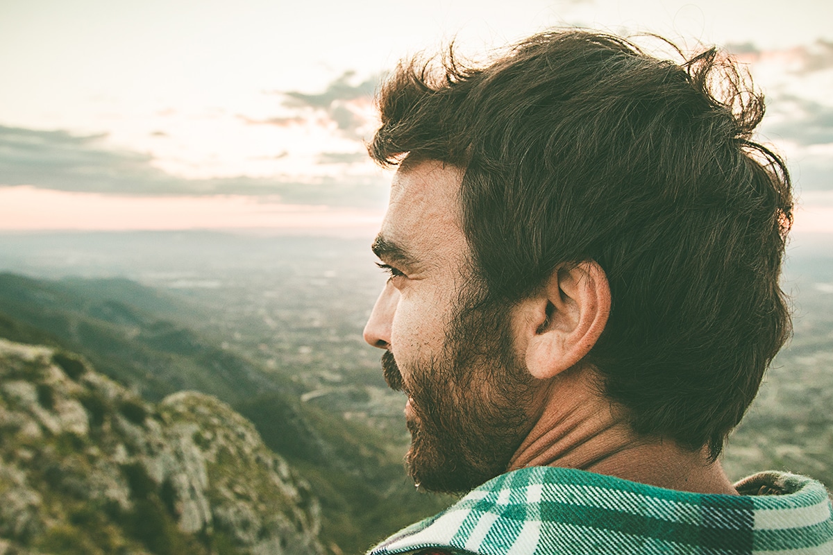man looking out from great height thanks to mindfulness based sobriety