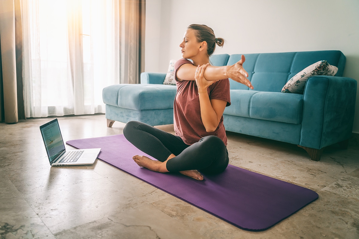 woman doing yoga as part of her stress management techniques