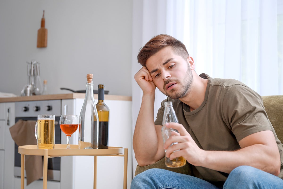 man drinking alone showing drug and alcohol abuse
