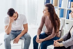 individual in group therapy at drug rehab