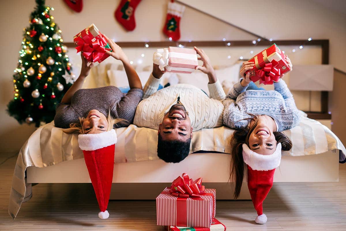family sitting upsidedown with presents for holiday season