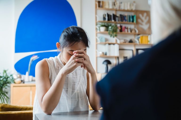 girl contemplative in conversation with therapist about isolation and mental health
