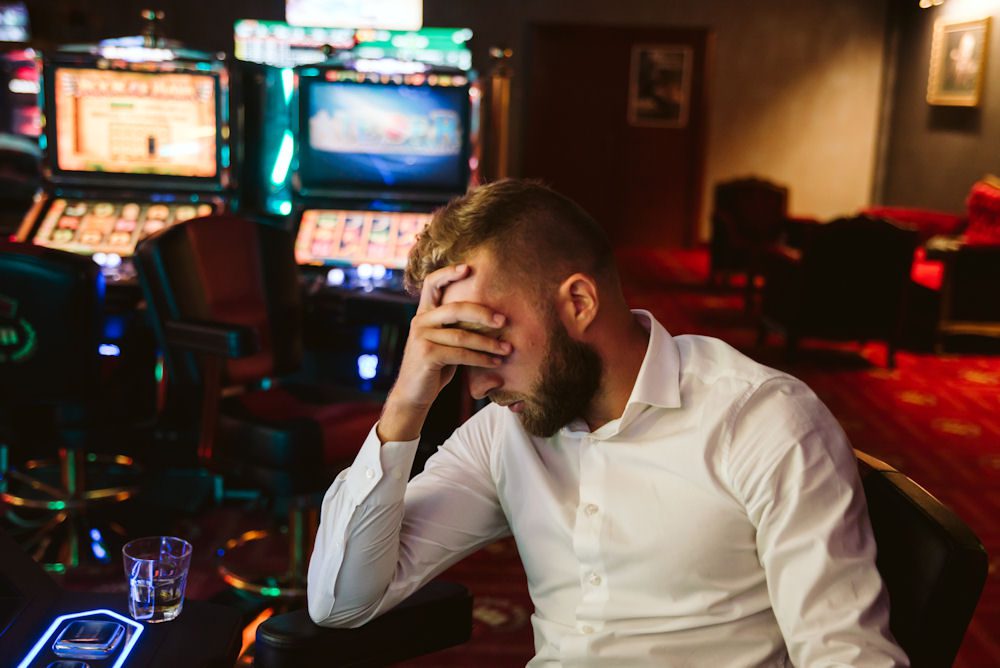 man struggling with gambling addiction and facing its personal challenges