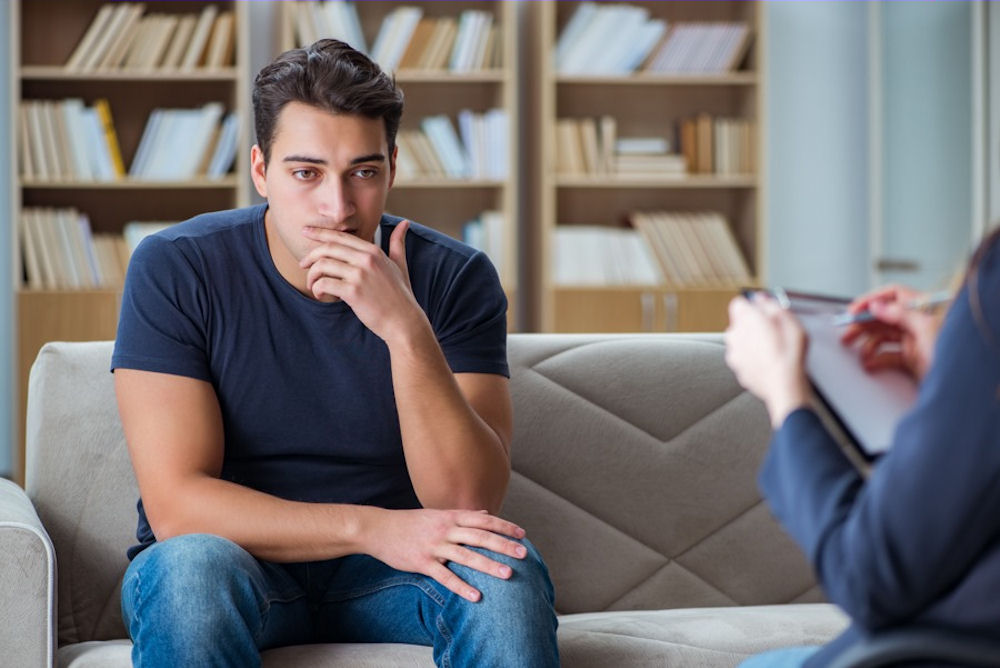 Therapist counseling a man facing men's mental health stigma
