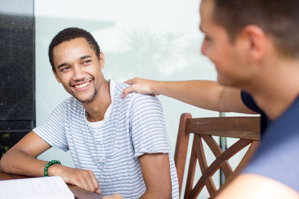 Smiling man receiving support against men's mental health stigma