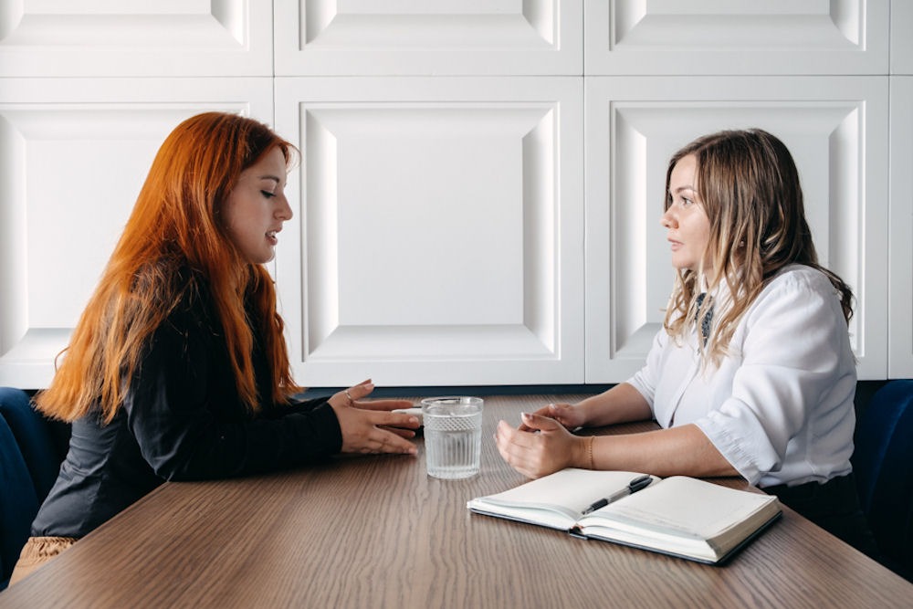 Teen discussing mental health concerns with a therapist at a one-on-one session