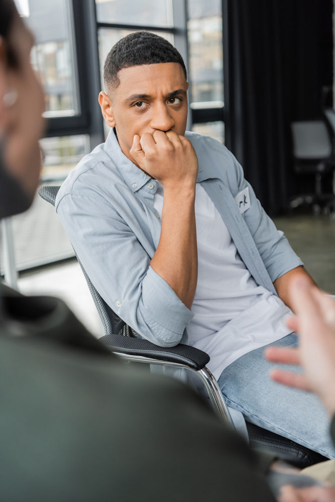 A man listening to his therapist in a CBT session