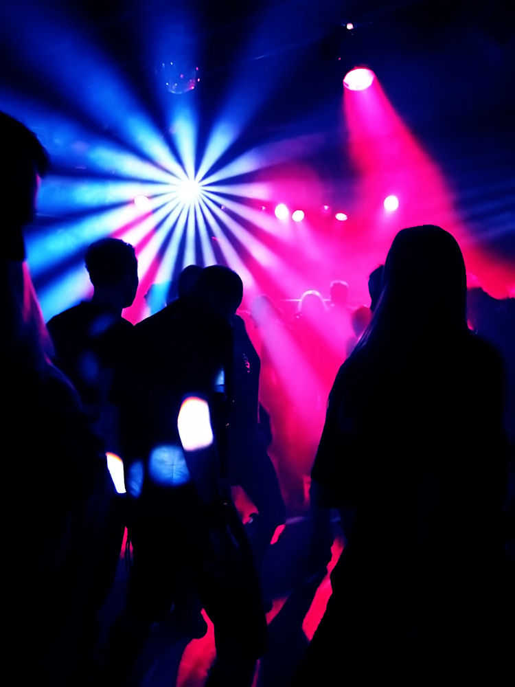 Party scene with individuals potentially using party drugs Party scene with individuals potentially using party drugs