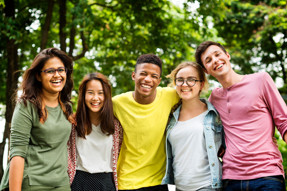 group of smiling teens outside in recovery