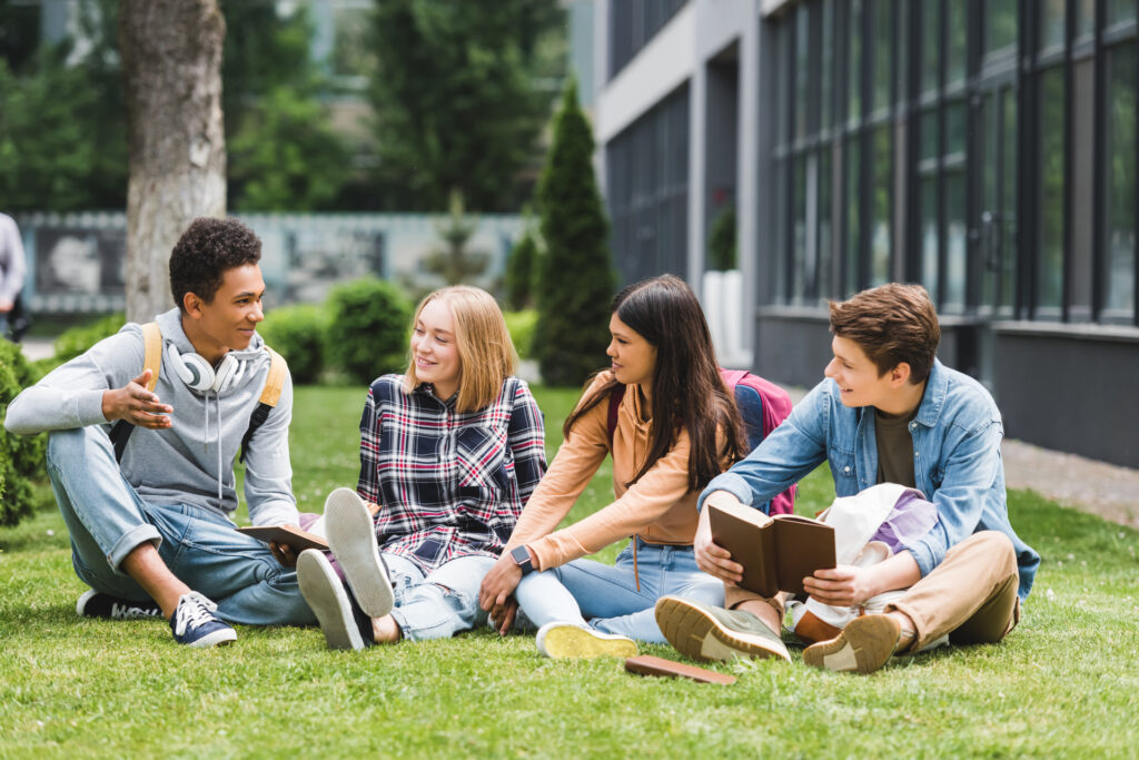 group of teens sitting outside afer school